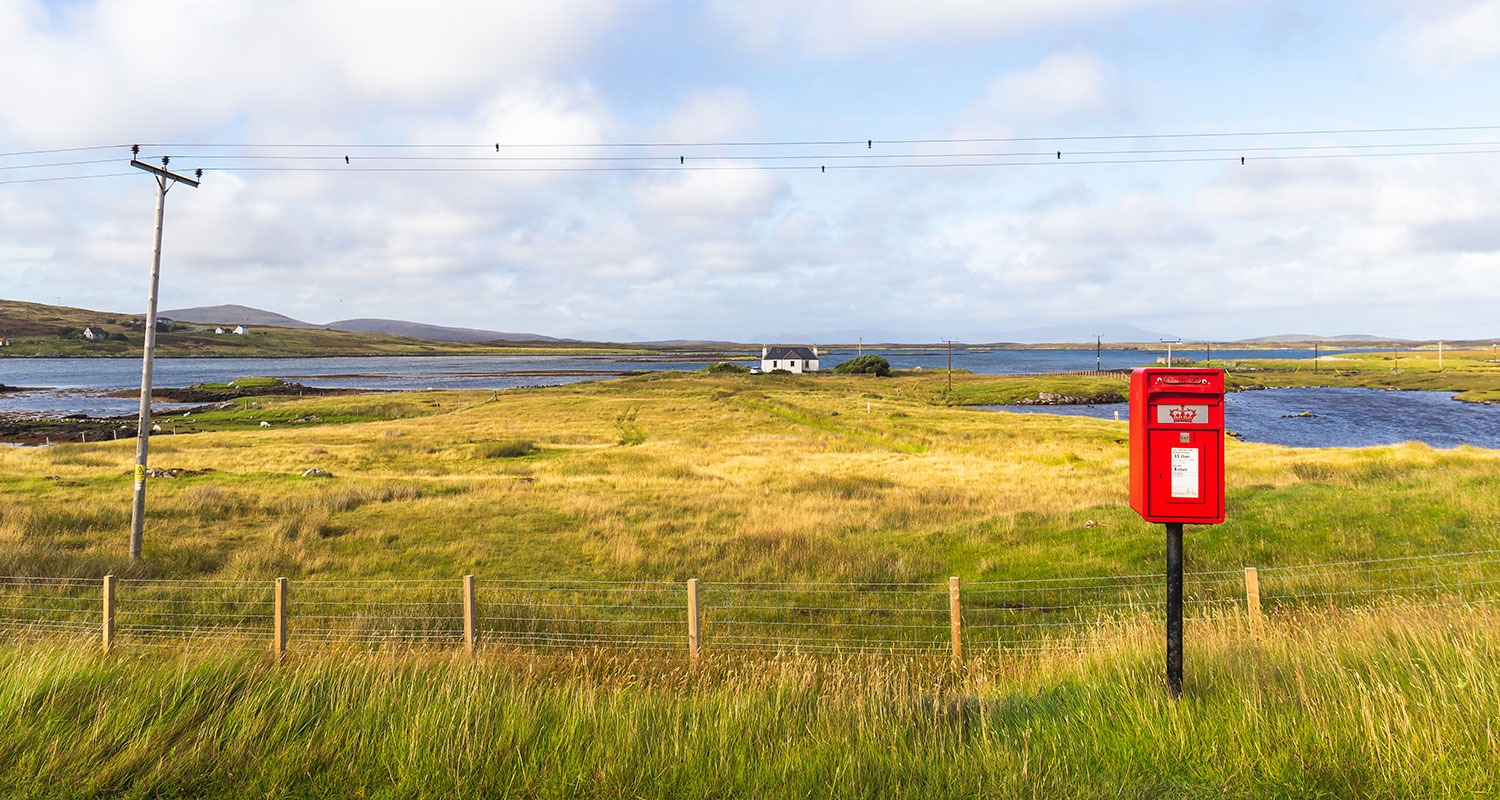 Remote croft by lochs in open landscape